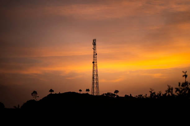 istock silhouette of Telecommunication tower Antenna at sunset on a hill 2195659534
