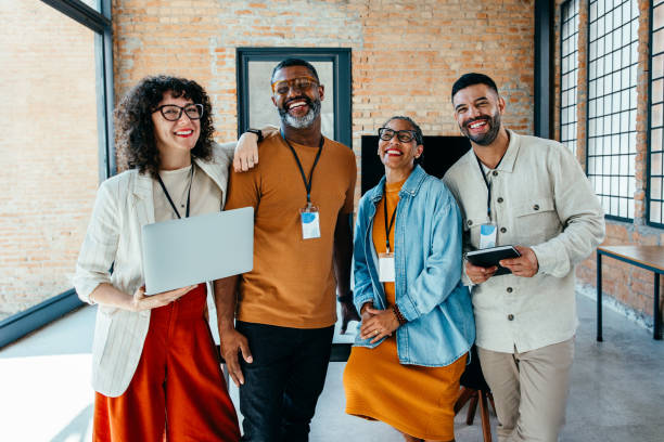 istock Diverse group of professionals smiling in a modern office setting 2195661937