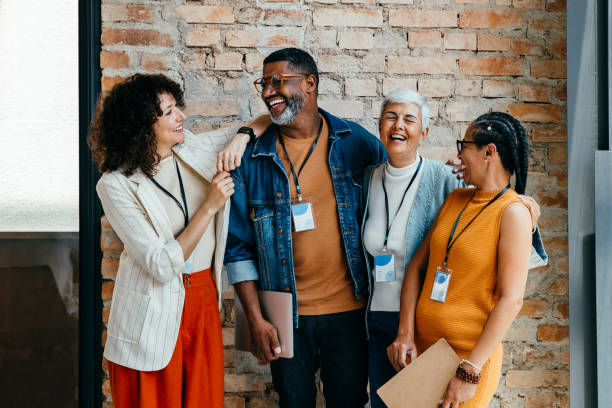 istock Multiethnic colleagues enjoying a casual conversation and laughter at work, showcasing diversity and teamwork in a positive office environment 2195661984