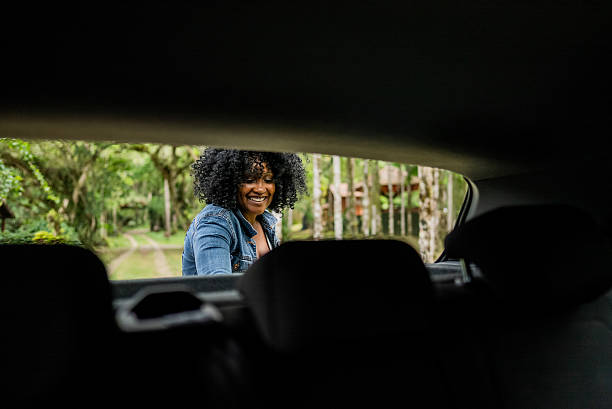 istock Mid adult woman unloading car trunk on hotel 2195663072