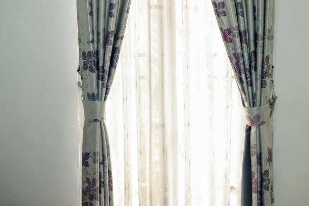 istock Floral curtain pattern with light shining through sheers creates calm atmosphere 2195663234