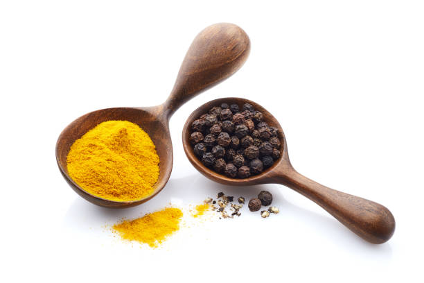 istock Turmeric powder with black peppers on white background 2195665196