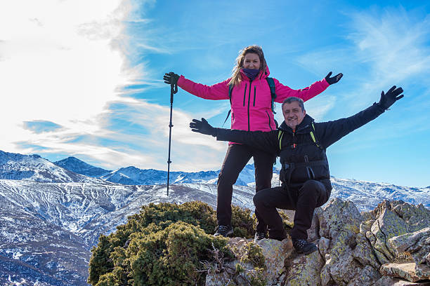 istock Hikers Celebrating at Snowy Mountain Summit 2195665372