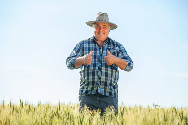 istock Smiling elderly male farmer looking at camera and showing thumbs up 2195666539