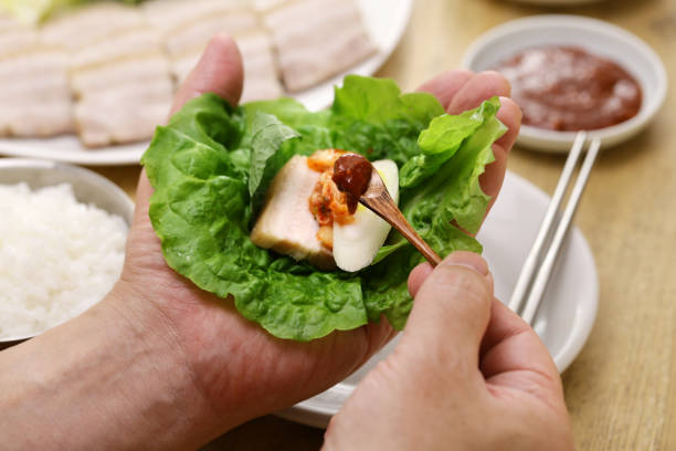 istock Bossam (sliced boiled pork belly wrapped with leaf vegetables ), Korean cuisine 2195669943