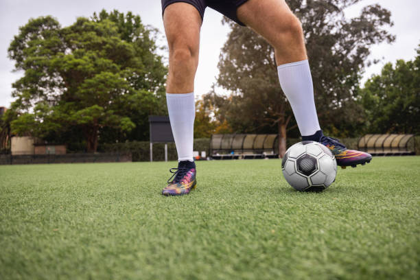 istock Soccer Player Standing on Field With Ball Ready for Action 2195671977