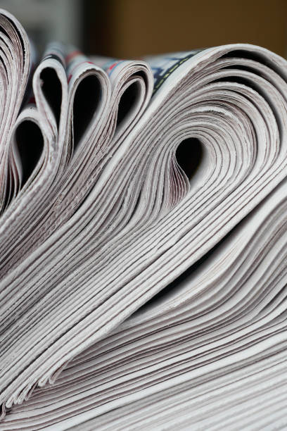 istock Pile of newspapers stacks on table . 2195672640