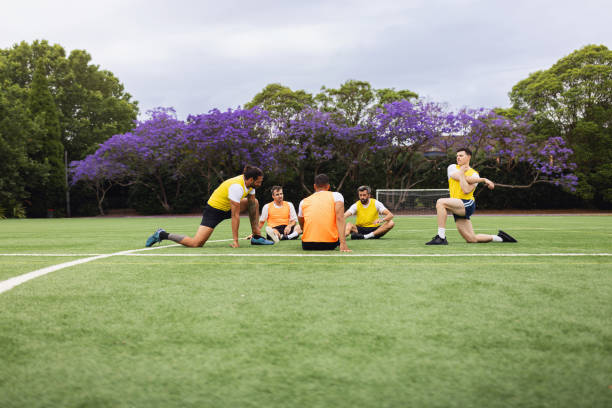 istock Group of Athletes Stretching During Football Training on a Field 2195672673