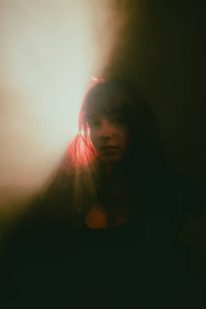 istock Woman breathing smoke in atmospheric lighting 2195675494
