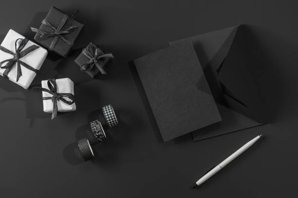 istock White and black gift boxes on a black background and a black envelope with space for text. Gifts for men, Happy Father's Day. 2195681661