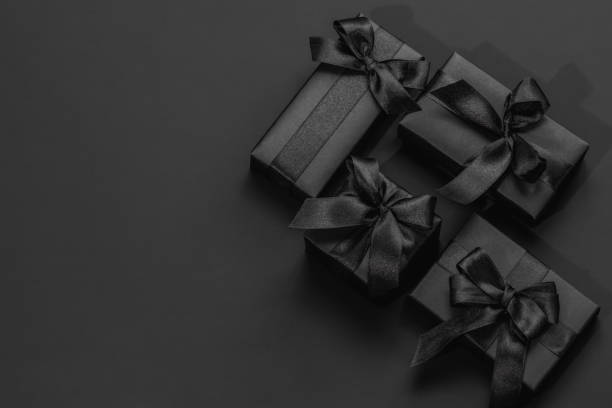 istock Black gift boxes on a dark black background with space for text. Gifts for him, happy father's day. 2195681707