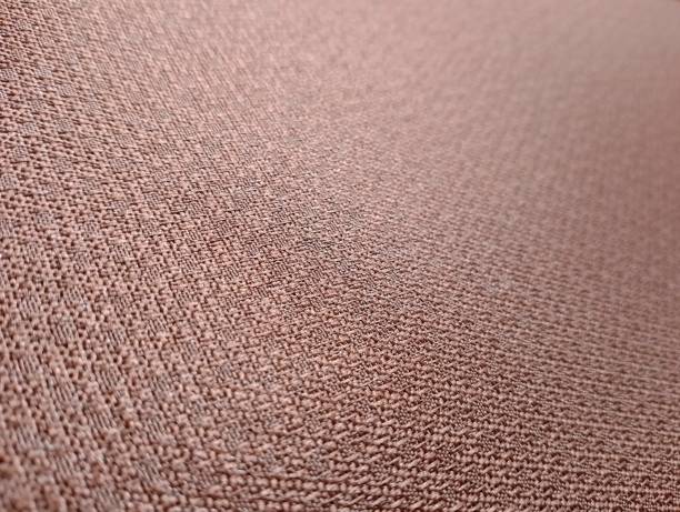 istock Close-up of a Textured Fabric Surface in a soft brown color with intricate weaving patterns 2195681767