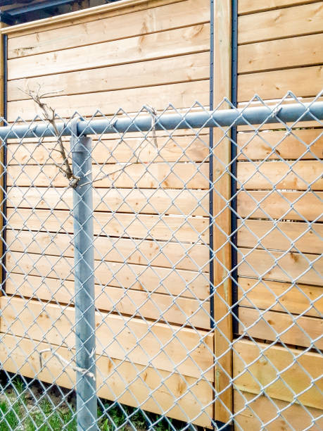 istock section of a privacy fence on a deck behind a chain link fence 2195683255