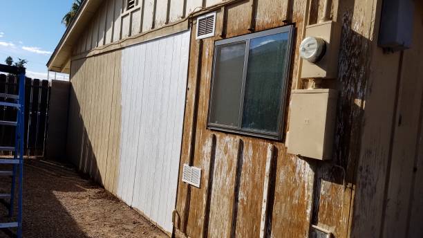 istock Exterior of a House Getting Remodeled, Removing Old Paint and Adding Primer 2195683990