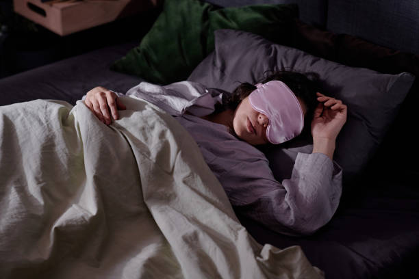 istock Woman Lying on Her Side in Bed 2195684153
