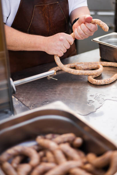 istock hobby sausage maker holding a meat-filled casing in his hands 2195686957