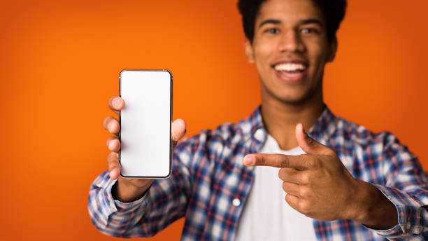 istock Mockup for advertisement. Guy pointing at blank screen phone 2195690587