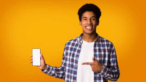 istock Present new app. Guy pointing at blank screen phone 2195690605