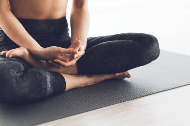 istock Practicing Mindfulness and Meditation on a Yoga Mat in a Serene Indoor Space 2195695341