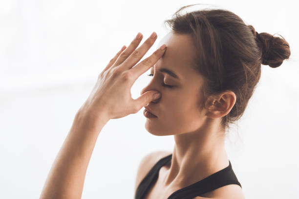 istock Woman Practicing Mindful Breathing and Relaxation Techniques in a Bright, Serene Space 2195695355