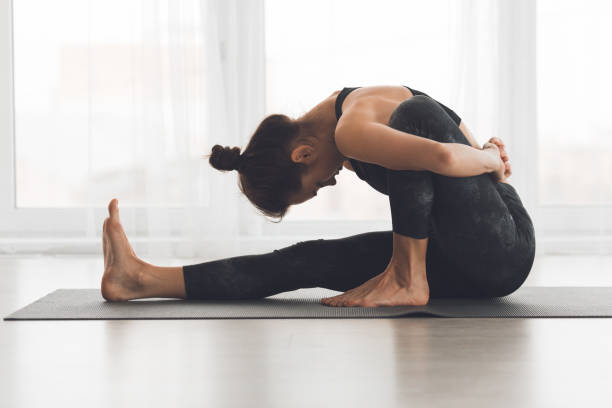 istock Yoga Practice in a Bright Studio Focusing on Deep Stretching and Flexibility 2195695362