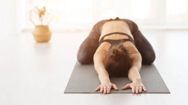 istock Stretching in a Yoga Studio During Morning Light for Relaxation and Mindfulness Practice 2195695553