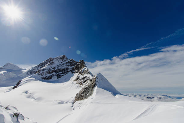 istock Majestic snow-capped mountains under a bright sun. 2195698466