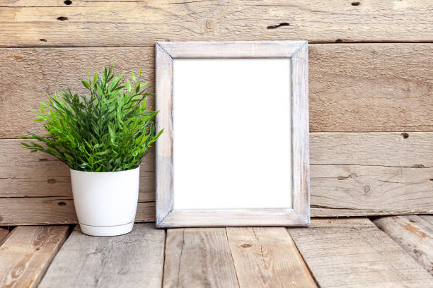 istock Wooden frame 8x10 on wooden background. Ideal for displaying your artwork. 2195698856