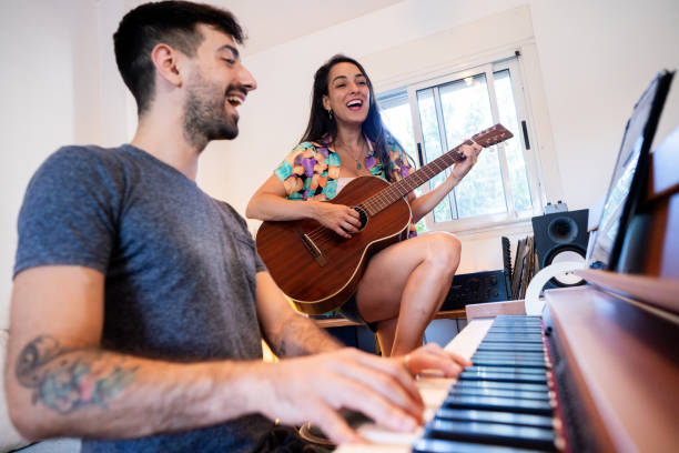 istock Musician friends playing guitar and piano at studio 2195699737