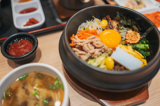 istock Traditional korean bibimbap served with authentic sides and sauces 2195700260