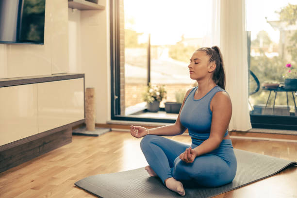 istock Woman Practicing A Yoga Routine At Home 2195701434