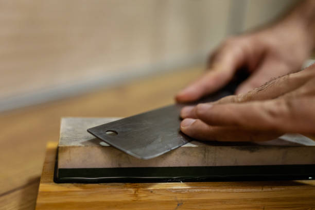 istock Close-Up Shot of a Kitchen Knife Being Sharpened on a Whetstone 2195702004
