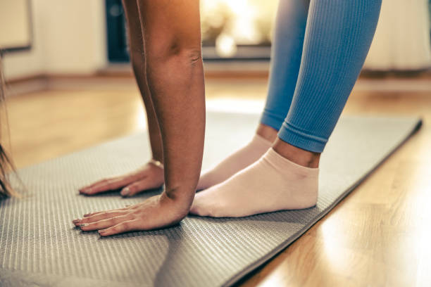istock Woman Practicing A Stretching Exercises At Home 2195702264