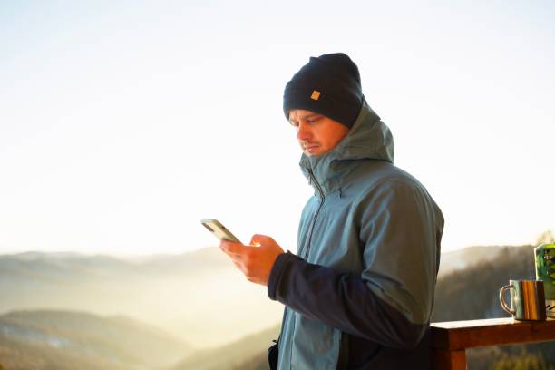 istock Young Man Checking Social Media While Hiking in the Mountains 2195702915