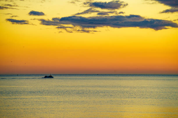 Fishing boats on sea water at sunrise. Seascape.