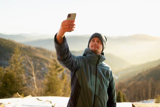 istock Young Man on a Video Call in a mountains 2195704603