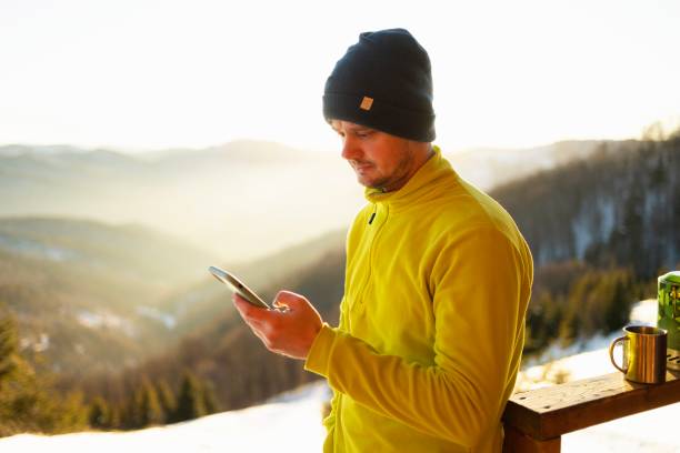 istock Young Man Checking social media while hiking in the Mountain Hut 2195705009
