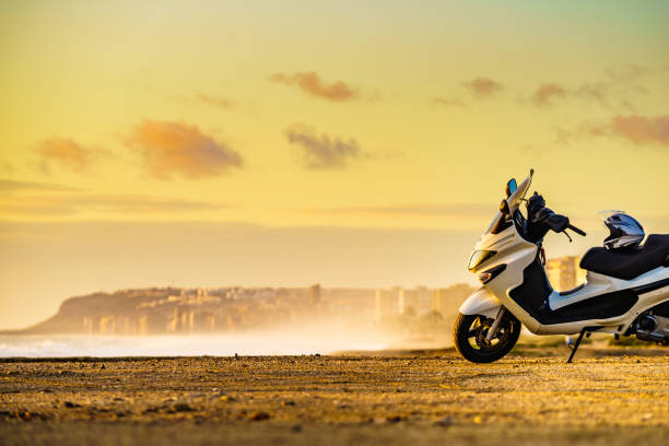 istock Scooter on beach at sunrise 2195705169