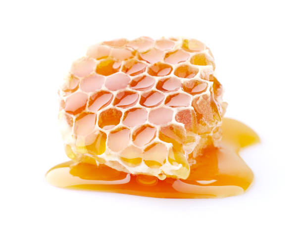 istock Honeycomb with honey drop on white background 2195705180
