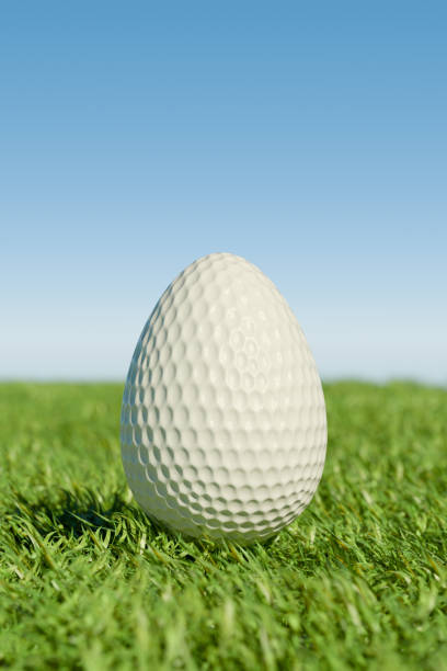 istock Easter golf ball shaped like an egg on grass under a clear blue sky. 3d rendering 2195715809