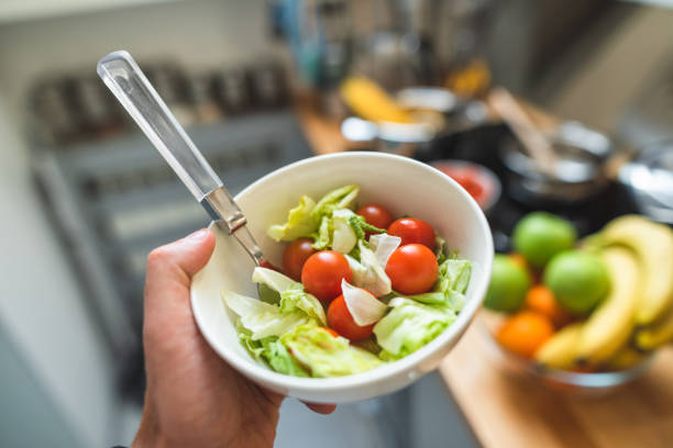 istock holding a pot of salad in the kitchen 2195716213