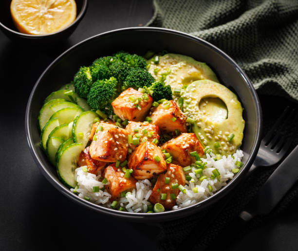 istock Salmon bowl with rice and vegetables, close up view. 2195718402