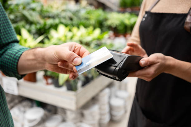 istock Florist Holding Card Reader for Customer Payment 2195718415