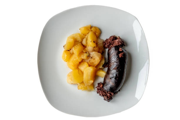 Homemade dish. A plate with a piece of black pudding cut and apple compote