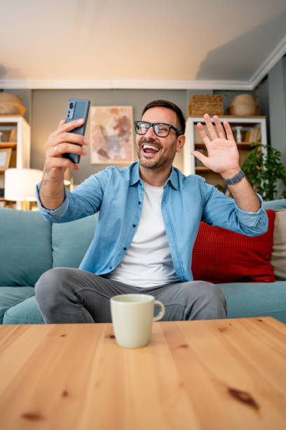 istock Man having a video call at home 2195719624