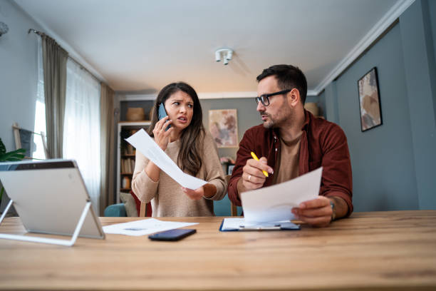 istock Worried young couple manages home finances 2195719718