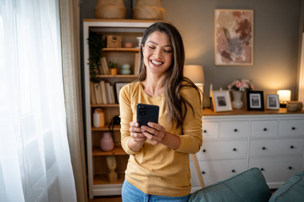 istock Young woman using phone at home 2195719893