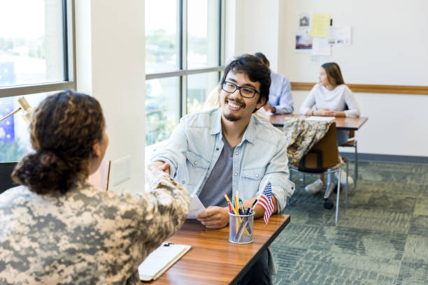 istock Smiling Man and Woman Veteran Shaking Hands in Office 2195720145