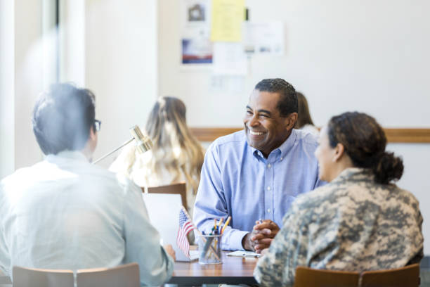istock Diverse group of adults in discussion, working together 2195720164