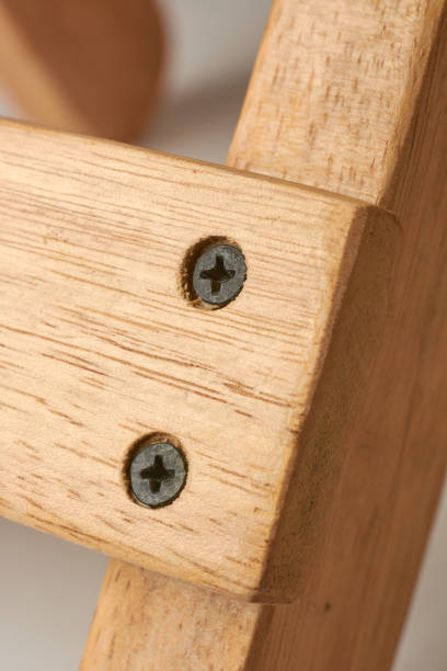 istock close-up of countersunk black screws into wood 2195720474